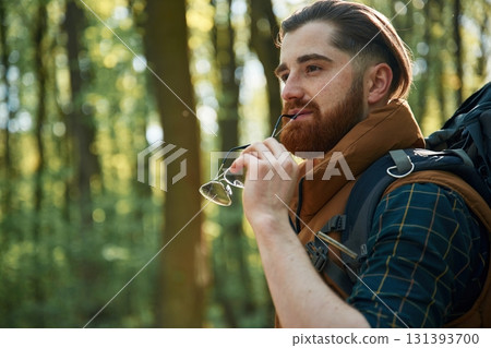 Bearded man is in the forest at daytime 131393700