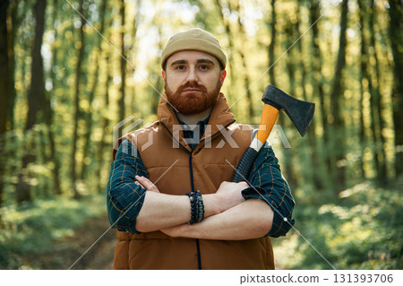 Woodcutter is standing. Bearded man is in the forest at daytime 131393706