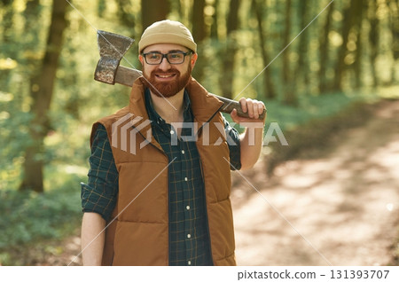 Woodcutter is standing. Bearded man is in the forest at daytime 131393707