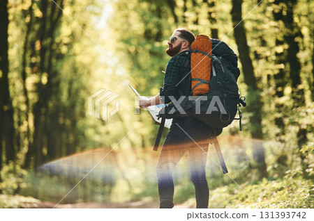 Beautiful lens effect. Bearded man is in the forest at daytime Beautiful lens effect. Bearded man is in the forest at daytime 131393742