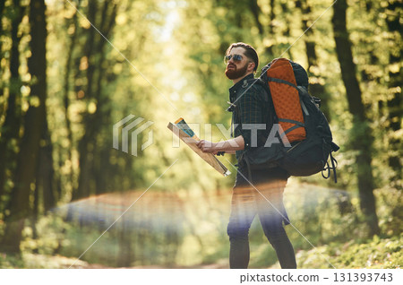 Beautiful lens effect. Bearded man is in the forest at daytime 131393743