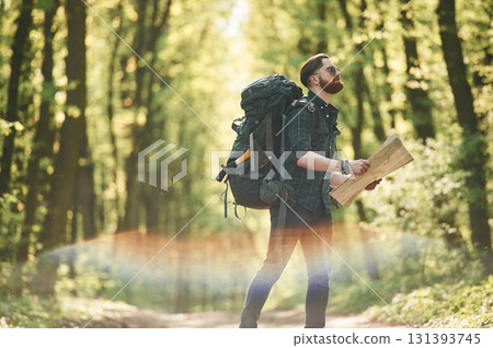 Beautiful lens effect. Bearded man is in the forest at daytime Beautiful lens effect. Bearded man is in the forest at daytime 131393745