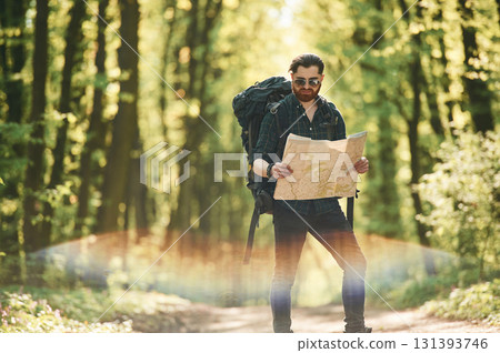 Beautiful lens effect. Bearded man is in the forest at daytime Beautiful lens effect. Bearded man is in the forest at daytime 131393746