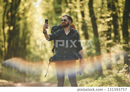 Colorful lens effect. Bearded man is in the forest at daytime 131393757
