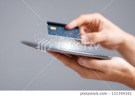 Digital wallet interface glowing on tablet with hand holding credit card, showcasing modern payment technology and financial transactions in a sleek, contemporary setting 131394381