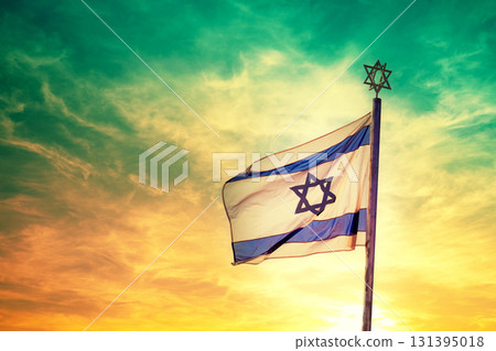 The flag of Israel flutters against the sunset sky The flag of Israel flutters against the sunset sky 131395018