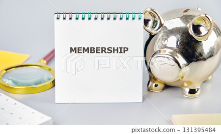 MEMBERSHIP word written in a notebook in a composition with a piggy bank and a magnifying glass. Business Web Promotion Marketing Concept. 131395484