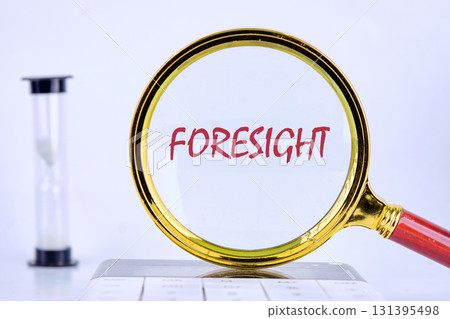 FORESIGHT text was revealed through a magnifying glass on a light background that was on the calculator. Planning and analytics concept. FORESIGHT text was revealed through a magnifying glass on a light background that was on the calculator. Planning and analytics concept. 131395498