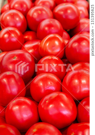 Red tomatoes are lying in transparent trays on the shop counter. Tomato theme background 131395625