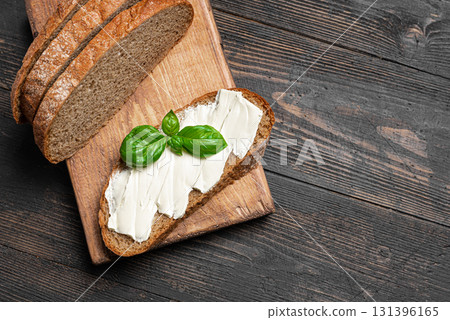Butter and bread on wooden board, copy space Butter and bread on wooden board, copy space 131396165
