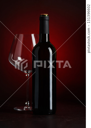 Wine Bottle and Empty Glass on Red and Black Gradient Background 131396602