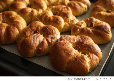 Freshly baked pumpkin-shaped sweet buns with almonds. Thanksgiving celebrating Freshly baked pumpkin-shaped sweet buns with almonds. Thanksgiving celebrating 131396606