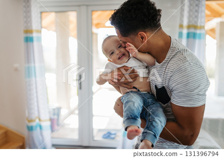 Father and small toddler son. Dad hodling and kissing boy. 131396794