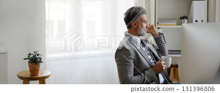Businessman making phone call in modern office. Businessman making phone call in modern office. 131396806
