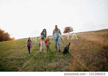 Happy young family with two children in autumn nature at sunset. Happy young family with two children in autumn nature at sunset. 131396833