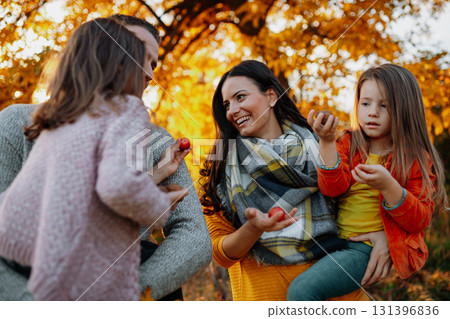 A portrait of young family with two small children in autumn nature at sunset. A portrait of young family with two small children in autumn nature at sunset. 131396836