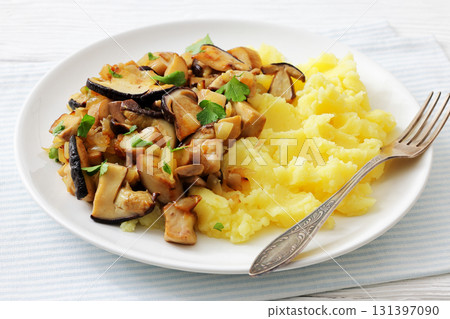 Fried porcini mushrooms with potato mash on plate Fried porcini mushrooms with potato mash on plate 131397090