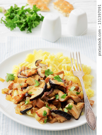 Fried porcini mushrooms with potato mash on plate Fried porcini mushrooms with potato mash on plate 131397091