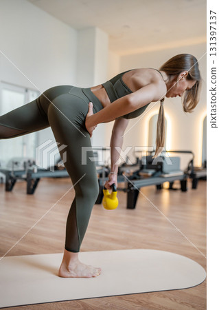 Foot work and core exercise with dumbbell illuminated by sunlight. Fit, healthy and strong authentical body. Fitness concept Foot work and core exercise with dumbbell illuminated by sunlight. Fit, healthy and strong authentical body. Fitness concept 131397137