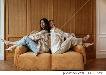 Happy playful free moments. Two young female best friends are indoors Happy playful free moments. Two young female best friends are indoors 131397295