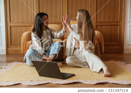 Happy playful free moments. Two young female best friends are indoors Happy playful free moments. Two young female best friends are indoors 131397319
