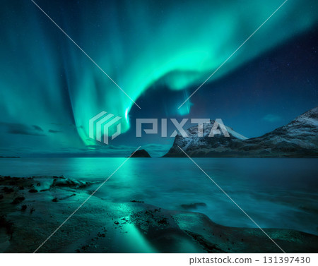 Aurora borealis on night starry sky over snowy mountains and sea Aurora borealis on night starry sky over snowy mountains and sea 131397430