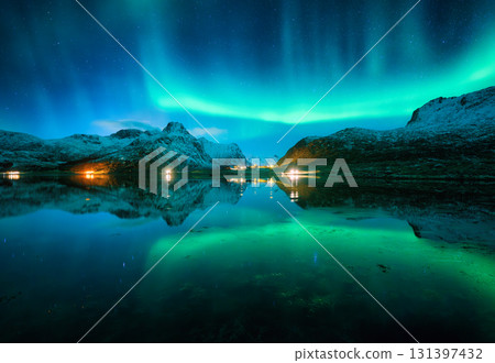 Aurora borealis and night starry sky reflected in lake in winter 131397432