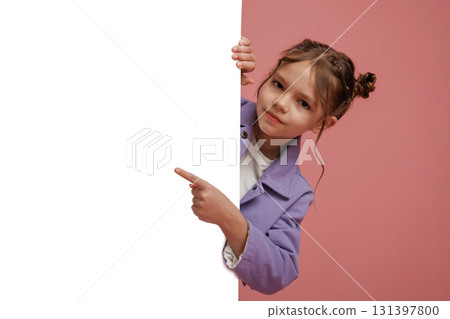 Showing at white copy space. Cute little girl is against pink background 131397800
