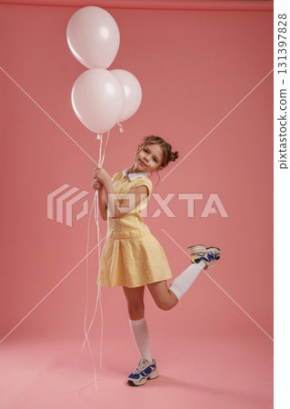 Bunch of balloons, party. Cute little girl is against pink background Bunch of balloons, party. Cute little girl is against pink background 131397828
