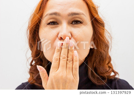 adult woman with wavy red hair blowing a kiss in a close-up shot. adult woman with wavy red hair blowing a kiss in a close-up shot. 131397929