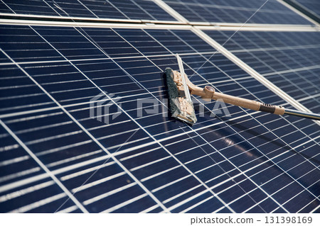 Close up view of cleaning solar panels surface Close up view of cleaning solar panels surface 131398169