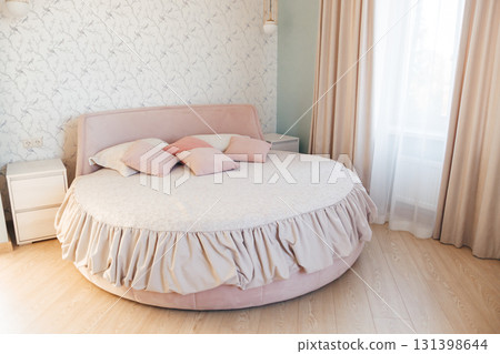The bedroom interior of a contemporary bedroom with a round bed The bedroom interior of a contemporary bedroom with a round bed 131398644