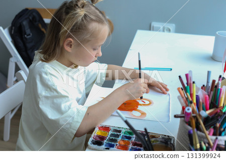 Creative young child painting at home. Close-up portrait of little girl indoor Creative young child painting at home. Close-up portrait of little girl indoor 131399924