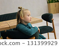 Little girl sitting in lobby lounge. Adorable child 6 years old 131399929