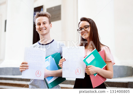 Education, university exam result concept. Two students received excellent results for final exam 131400805