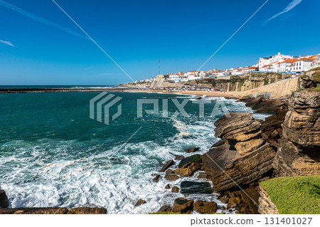 Scenic view of Praia do Sul in Ericeira, Portugal with golden sand, turquoise waters, and coastal buildings Scenic view of Praia do Sul in Ericeira, Portugal with golden sand, turquoise waters, and coastal buildings 131401027