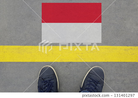 Start on an asphalt road with the Polish flag and legs in shoes. Business, Immigration and Travel  131401297