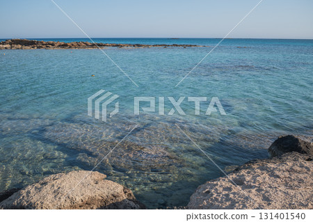Rocky Sea Entrance at Elafonisi Beach with Clear Turquoise Water - Natural Coastal Texture of Crete Rocky Sea Entrance at Elafonisi Beach with Clear Turquoise Water - Natural Coastal Texture of Crete 131401540