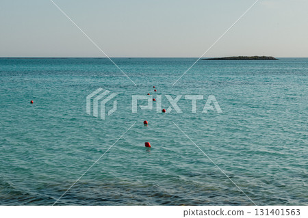 Red Safety Buoys Floating in Clear Blue Water at Rocky Entrance of Elafonisi Beach, Crete 131401563