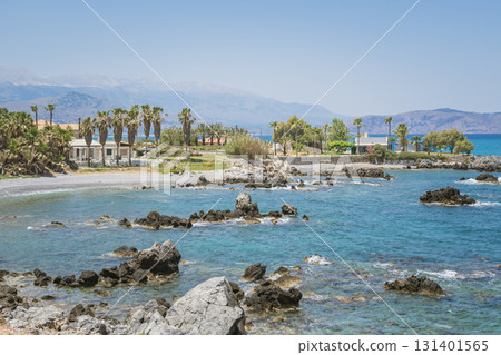 Cozy exotic cretan house by the sea surrounded by greek tall palm trees, Mediterranean landscape Cozy exotic cretan house by the sea surrounded by greek tall palm trees, Mediterranean landscape 131401565