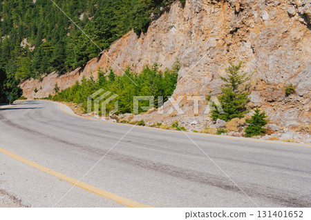 Mountain road section in Crete near Omalos in White Mountains with pine trees. 131401652