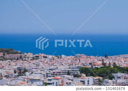 Panoramic view of the Greek city of Rethymno from a height on the island of Crete Greece. Residential buildings and the Aegean sea Panoramic view of the Greek city of Rethymno from a height on the island of Crete Greece. Residential buildings and the Aegean sea 131401679