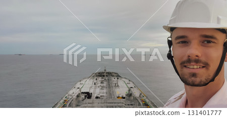 Sailor officer in white helmet, job on ship with sea background with copy space. 131401777