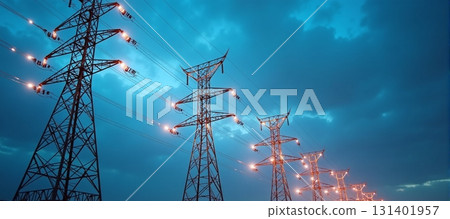 Power lines glow and stretch across a blue evening sky 131401957