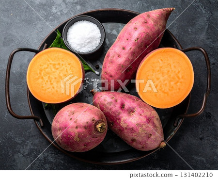 Autumn flavors: A dinner table with harvested sweet potatoes Autumn flavors: A dinner table with harvested sweet potatoes 131402210