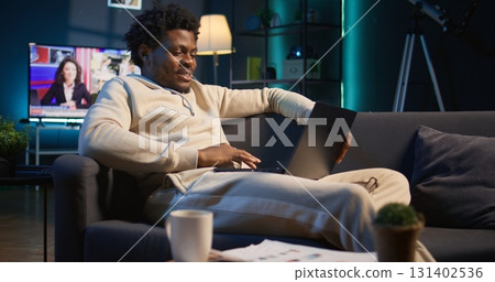 Home office user actively participating in a teleconference for remote workshop, maintaining a strong digital connection for effective online course. Man joining virtual call connection. Camera B. 131402536