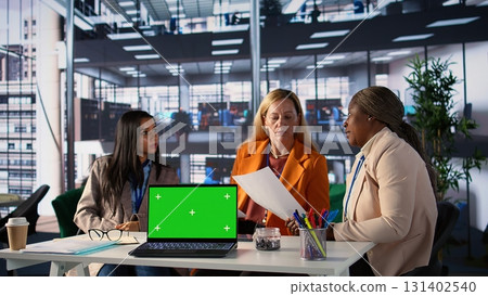 Team of goal oriented general managers discuss about goals next to copy space, using analytics and global information to work on expansion. Working hard to obtain funds for objectives. Camera B. 131402540