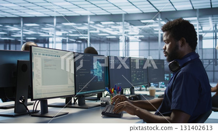 Woman assisting data center programmer in solving tasks, maintaining company network infrastructure. Supervisor in server room helping employee ensuring optimal system performance Woman assisting data center programmer in solving tasks, maintaining company network infrastructure. Supervisor in server room helping employee ensuring optimal system performance 131402613