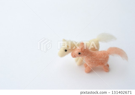 Wool felt horses lined up on a white background Wool felt horses lined up on a white background 131402671