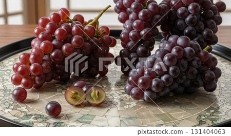 Fresh Red Grapes on Mosaic Plate with Cut Grape Cross Section 131404063